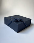 Blue gift box with a blue ribbon on a white background