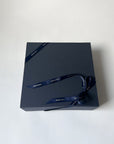 Dark blue gift box with a ribbon on a white background