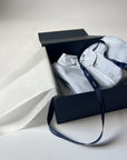 Blue and white striped shirt in a black box on a light gray background