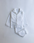 White pajama set on a light gray background