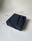 Navy gift box with dimensions on a light gray background