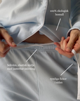 Light blue pajama set with text highlighting features on a gray background