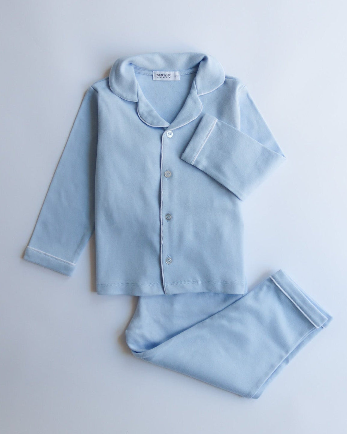 Light blue pajama set on a light gray background