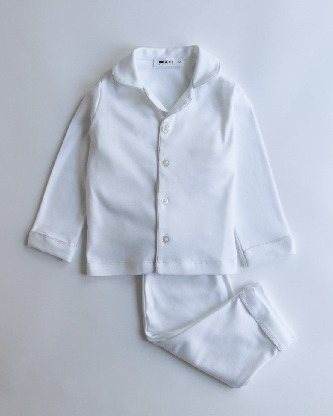 White pajama set on a light gray background